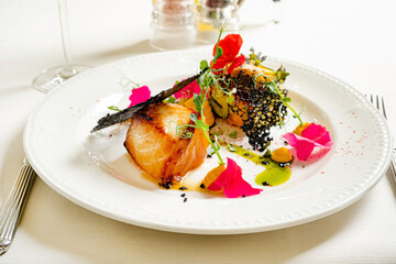 fish steak with puree on white plate
