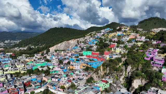 Aerial view of colorful mountain village of San Cristobal de Las Casas in Mexico. Clouds over the mountains. 