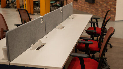 Empty office open space. Coworking space with white desks.