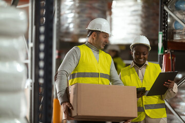 A shot of a man and woman working in a distribution warehouse, the manager is giving instructions...