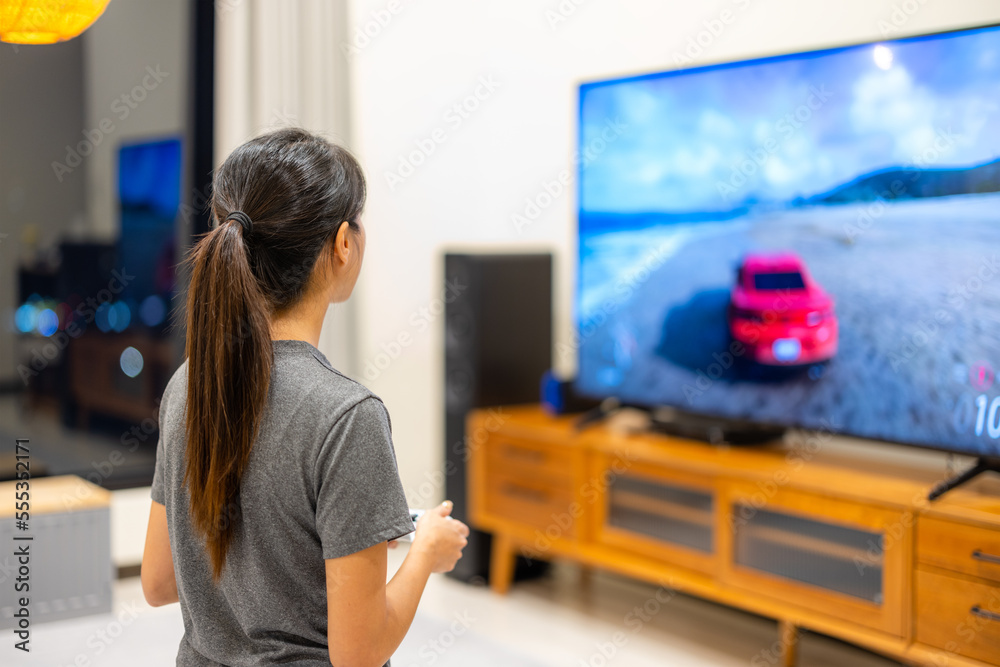 Wall mural woman play the video game at home