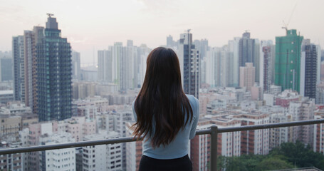 Fototapeta na wymiar Woman look at the city scenery view in the evening