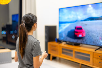 Woman play the video game at home