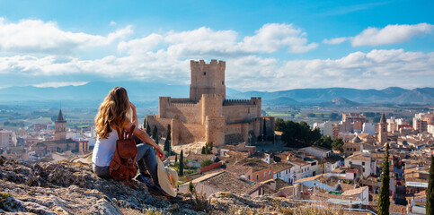 woman tourist looking at panoramic view of Atalaya castle,  Alicante province in Spain - obrazy, fototapety, plakaty