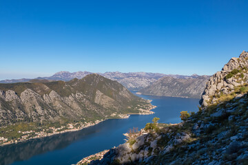 Panoramic view of the bay of Kotor during sunrise in summer, Adriatic Mediterranean Sea, Montenegro, Balkan Peninsula, Europe. Fjord winding along the coastal towns. Lovcen and Orjen mountain range
