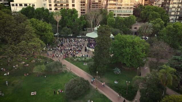 Aerial footage of a band playing in bandshell in La Glorieta park in Barrancas de Belgrano near Buenos Aires in Argentina