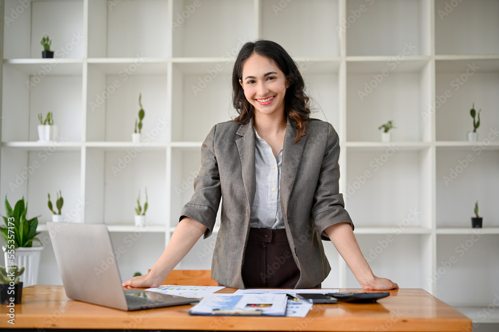 Sticker successful and confident millennial asian businesswoman or female ceo at her office desk.