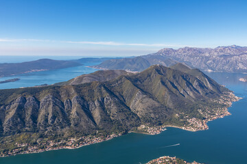 Panoramic view from Derinski Vrh of Kotor bay on sunny summer day, Adriatic Mediterranean Sea, Montenegro, Balkan Peninsula, Europe. Fjord winding along the coastal towns. Lovcen, Orjen mountain range