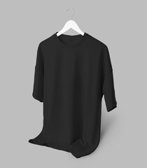 Template of black oversized t-shirt, unisex clothing hanging on a wooden hanger, isolated on background, front view.