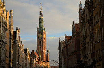 Fototapeta na wymiar City hall clock tower in Gdańsk, Poland at sun dusk