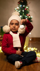 happy Indian child boy with christmas tree 