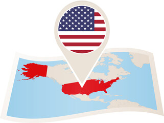Folded paper map of USA with flag pin of United States of America.
