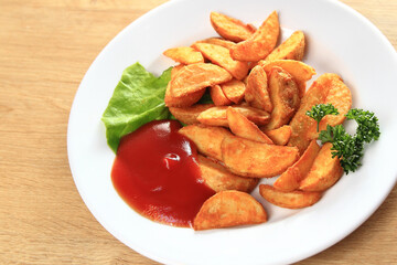 village-style potatoes with sauce on lettuce leaves