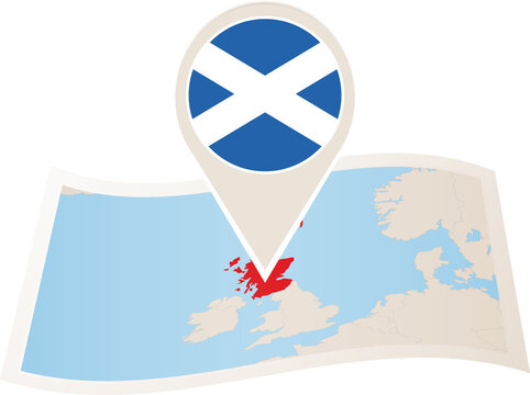 Folded paper map of Scotland with flag pin of Scotland.