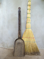 Old broom, cleaning supplies near the wall close-up