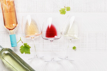 White, rose and red wine glasses and bottles