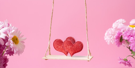 A swing with two hearts on pink background. Creative banner for Happy Valentines Day