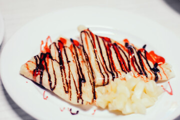 thin pancakes with pineapple slices with ginger sauce