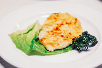 juicy chop and lettuce on white plate