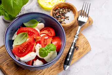 Caprese salad with ripe tomatoes, mozzarella and garden basil