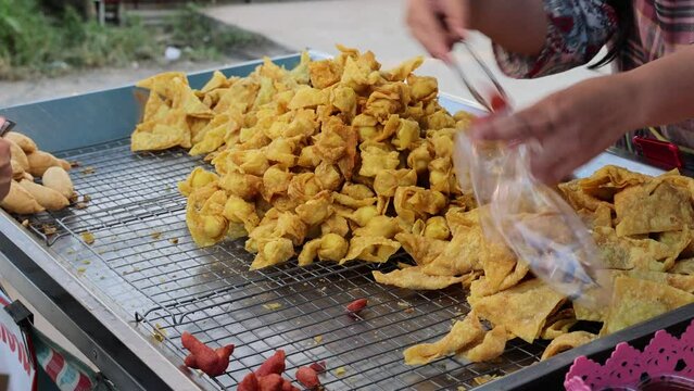 Packing Thai snacks called kuay tiew into plastic bag