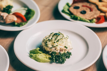 plate chicken salad with cucumber on the table