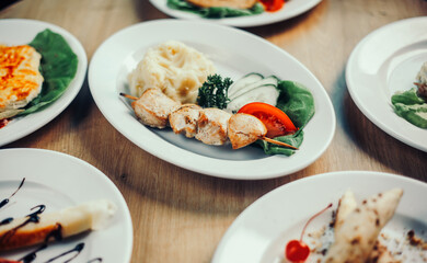 portion of kebab with mashed potatoes and other dishes on the table