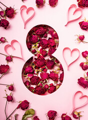 Flowers in the shape of a figure eight with hearts on a pink background. International Women's Day. Postcard for March 8. banner Copy space.