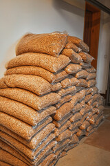 Wooden pellets storage. Alternative fuel concept. Heating household with renewable eco energy. Pressed sawdust for warming water and interiors.