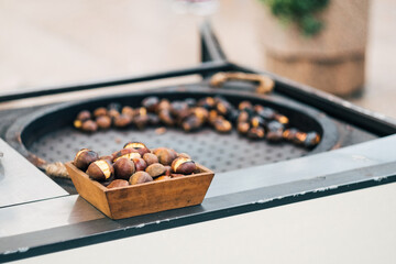 Traditional winter street food - chestnuts grilled on open fire