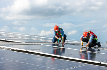 Engineer working setup Solar panel at the roof top. Engineer or worker work on solar panels or solar cells on the roof of business building