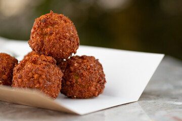 food delivery, falafel takeaway food, paper containers with falafel balls and sauce.