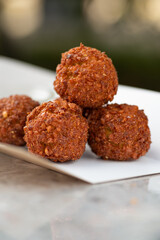 food delivery, falafel takeaway food, paper containers with falafel balls and sauce.