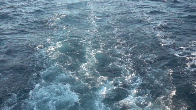 Wake Waves From Large Speed Boat Ship Traveling In Open Ocean Leaving Island