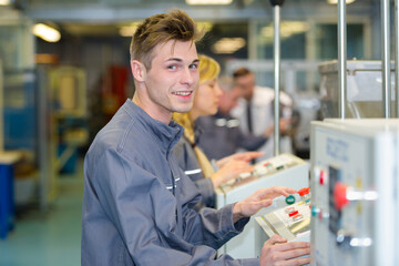 factory skilled worker pressing the button