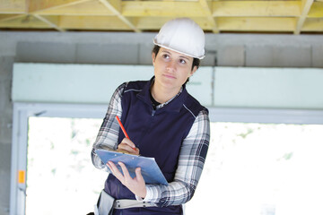 female builder holding a clipboard