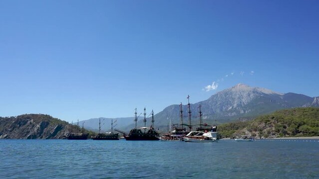 Touristic Galleons And Tour Boats Docked At Phaselis Beach, Antalya, Turkey