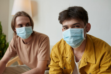 Fototapeta na wymiar Portrait of young college students wearing medical masks