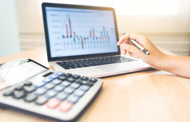 Accountant working in laptop computer on desk