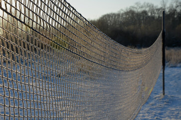 playing net on the lawn football field, badminton, tennis court, in the countryside at the cottage in the school in the yard, forest nursery for children, summer camp in the mountains  in winter, snow