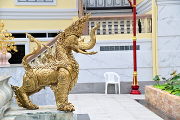 BANGKOK, THAILAND - JANUARY 21, 2023 : The Golden Elephant Statue located inside a Thai Buddhist temple Decorate the temple area beautifully at Thailand.