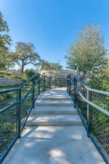Paved pathway with steps and rails for visitors of Waterloo park in Austin Texas