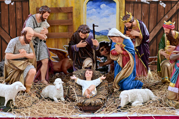 Statuettes of Mary, Joseph and baby Jesus,The birthday of Jesus is a statuette of Maria with Joseph and newborn Jesus on the hay, A Christmas nativity scene.