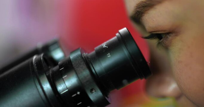 Close up shot, Selective focus eye of professional female veterinarian looking through microscope in laboratory, Smart scientist doing research for biology and medical science of animals