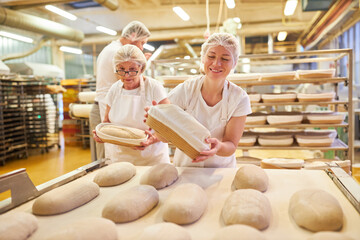 Baker as an apprentice and older colleague baking bread