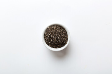 Chia seeds in bowl on colored background. Healthy Salvia hispanica in small bowl. Healthy superfood
