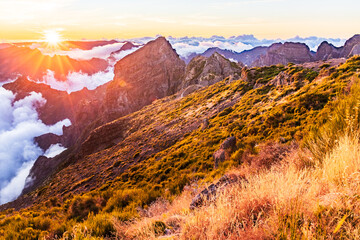Obraz premium sunset over the mountains, Madeira, Portugal. Clouds over the valley. Pico do Arieiro mountain