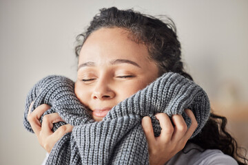 Happy, woman and fresh laundry in home with satisfied smile on face feeling clean wool sweater. Happiness, wellness and hygiene of girl cleaning in laundry room at house touching soft texture.