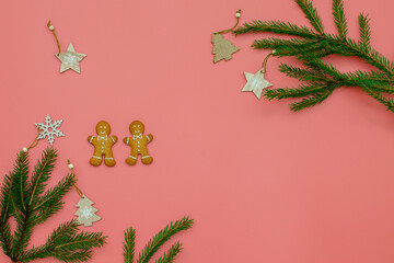 Banner with Christmas glazed gingerbread and Christmas tree branches on a pink background. Place for text on top. The concept of festive New Year's baking