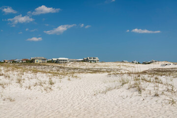 White sand dunes with grasses near the residential area at Destin, Florida